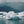 Icebergs floating in water with mountains in the background